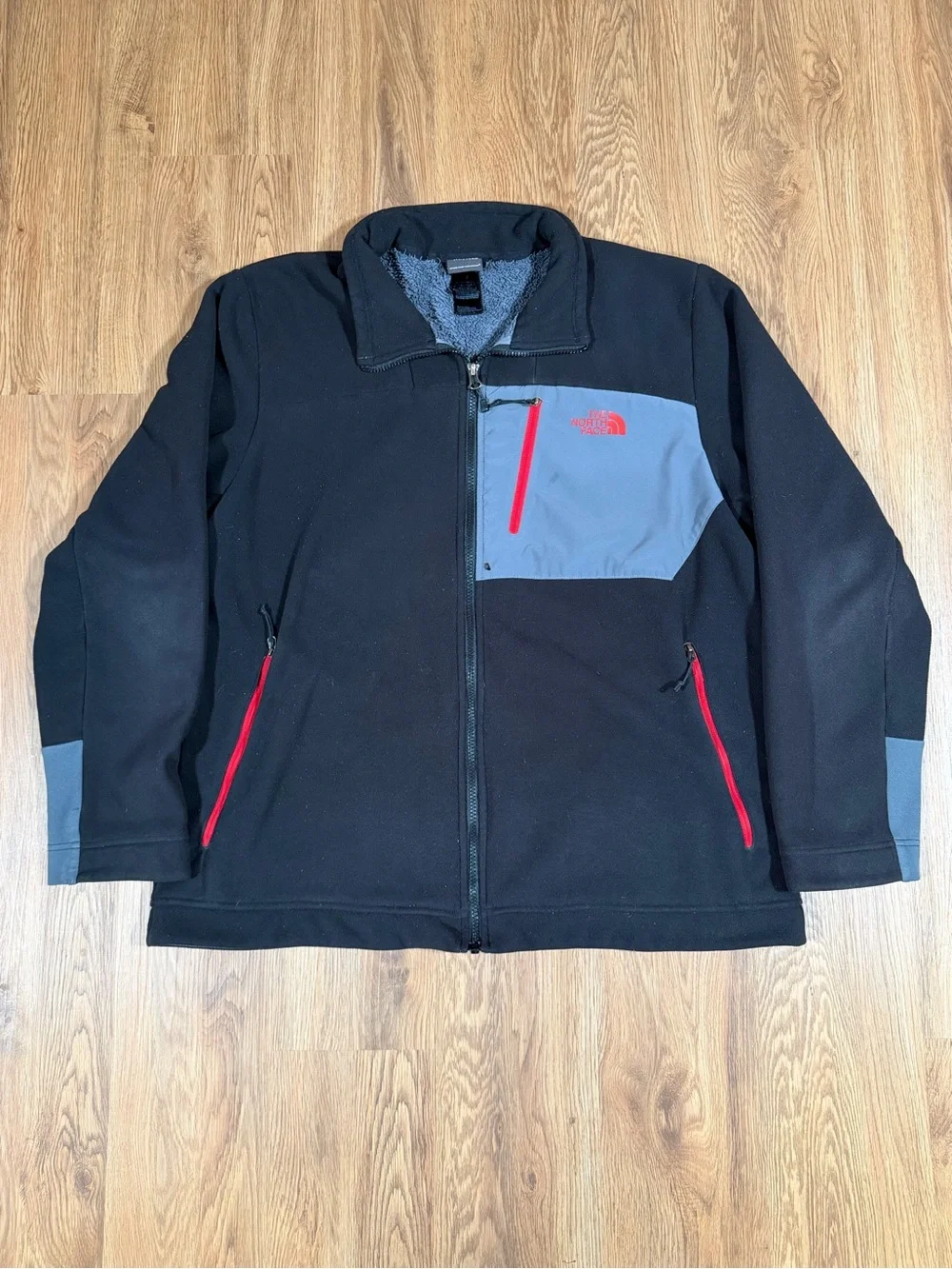 The North Face Black Fleece Jacket with Gray Chest Panel and Red Zippers